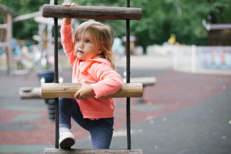 A child trying to climb a ladder